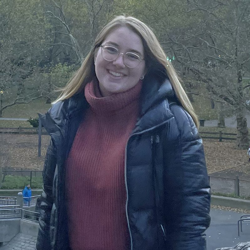 Coach Lindsay Gillikin standing outside wearing a long coat.